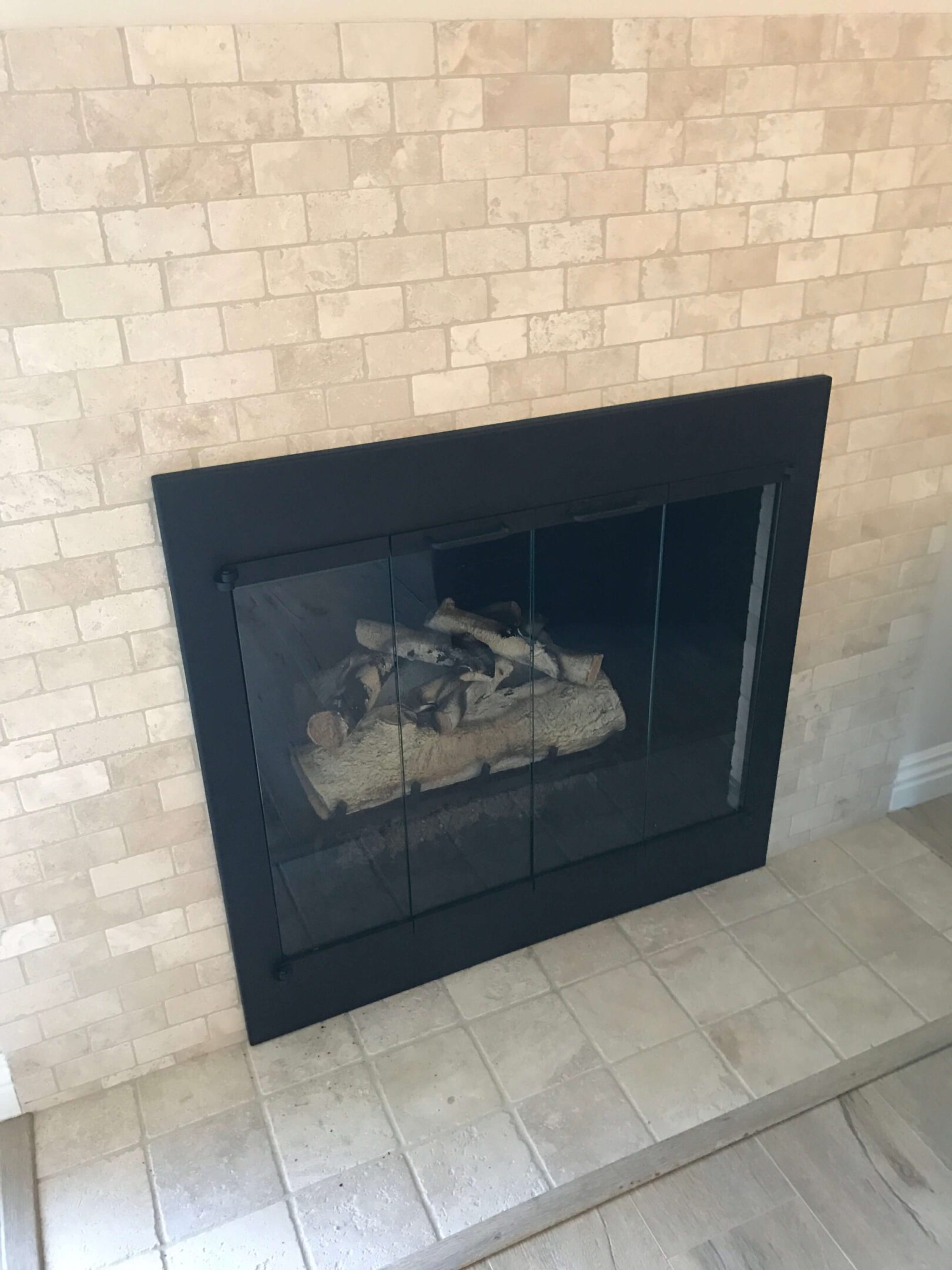 Black-framed fireplace on tiled floor